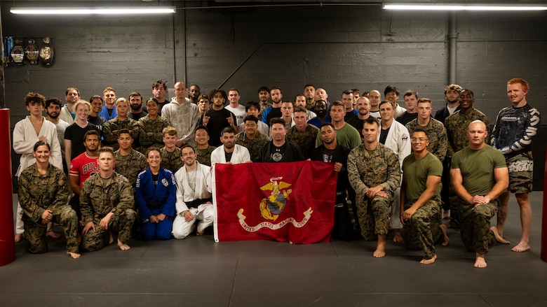 U.S. Marines assigned to Special Purpose Marine Air-Ground Task Force-250 pose for a group photo with members of Broadway Jiu-Jitsu after a martial arts collaboration at Broadway Jiu-Jitsu during Marine Week Boston, Aug. 22, 2025. Marines stationed across the globe commemorate the 250th anniversary of the Marine Corps, honoring a distinguished legacy of service, sacrifice, and unwavering fidelity to both the nation and fellow Marines. (U.S. Marine Corps photo by Cpl. Vincent Needham)
