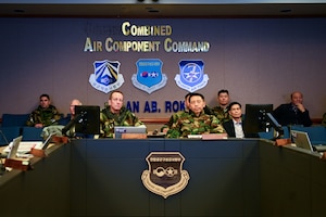 two men sit at conference room table