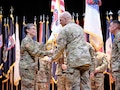 – Lt. Gen. Johnny Davis, commanding general U.S. Army Recruiting Command passes the Recruiting colors to Brig. Gen. Sara Dudley symbolizing the assumption of command for the newly-designated U.S. Army Recruiting Division during a ceremony at Waybur Theater, Fort Knox, Ky. Dudley was joined by Command Sgt. Maj Danny Basham, who assumed responsibility of USARD.
