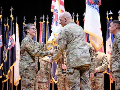 – Lt. Gen. Johnny Davis, commanding general U.S. Army Recruiting Command passes the Recruiting colors to Brig. Gen. Sara Dudley symbolizing the assumption of command for the newly-designated U.S. Army Recruiting Division during a ceremony at Waybur Theater, Fort Knox, Ky. Dudley was joined by Command Sgt. Maj Danny Basham, who assumed responsibility of USARD.