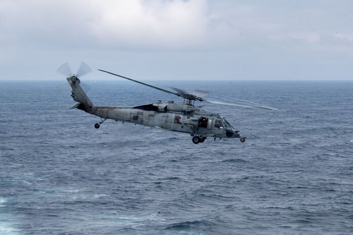 250822-N-UP681-1135 NORTH PACIFIC OCEAN (Aug. 22, 2025) An MH-60S Sea Hawk helicopter, attached to Helicopter Sea Combat Squadron (HSC) 14, takes off from the flight deck of the Nimitz-class aircraft carrier USS Abraham Lincoln (CVN 72) during exercise Northern Edge 2025 (NE25). NE25 is an exercise led by U.S. Indo-Pacific Command that serves as a platform for joint, multi-domain operations to deliver high-end, realistic warfighter training, strengthen joint interoperability, and sharpen the air and sea-based combat readiness of U.S. and participating forces. (U.S. Navy photo by Mass Communication Specialist Seaman Apprentice Gage Thomas)