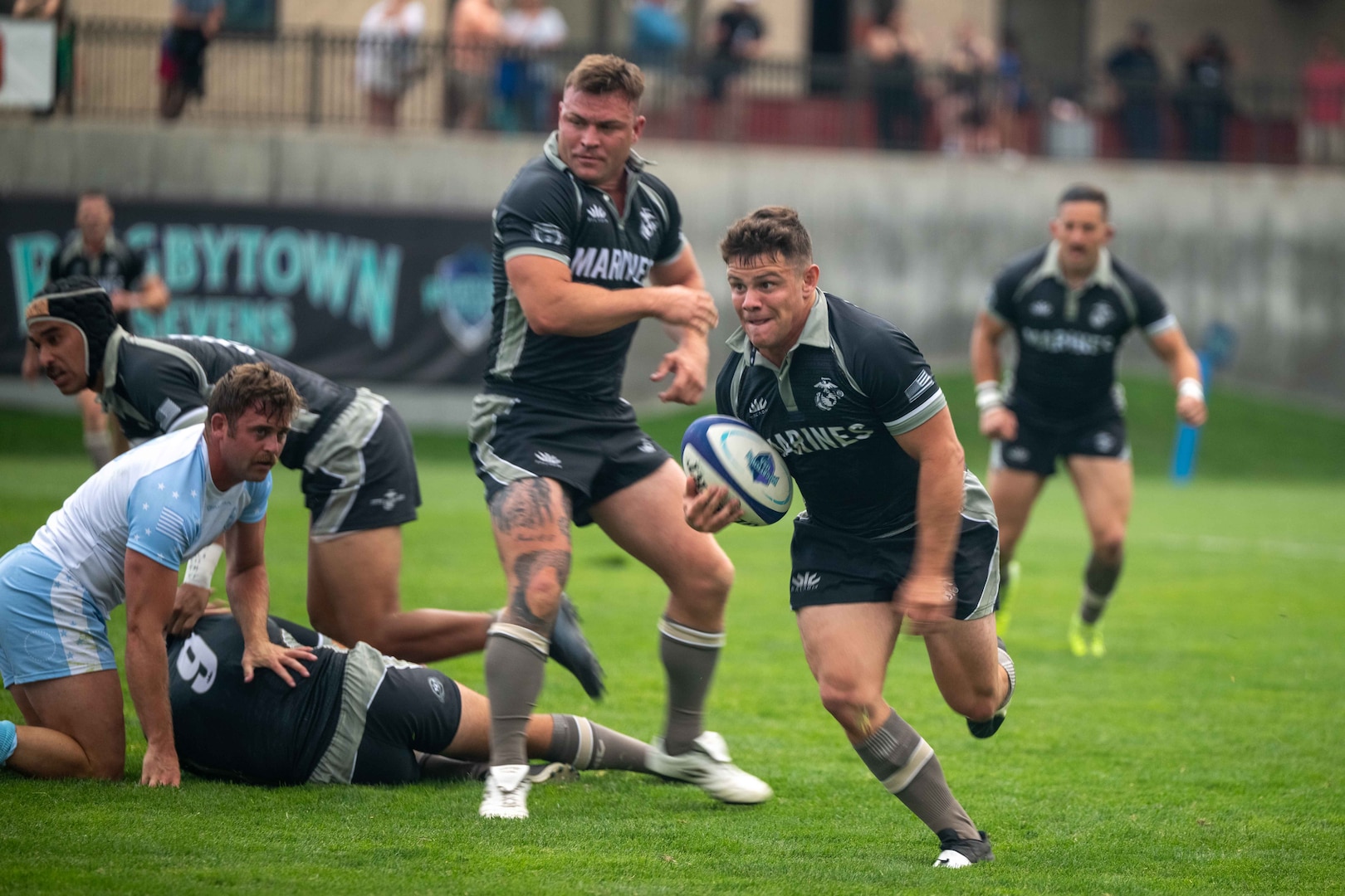 U.S. Marine Corps Lance Cpl. Luis Camacho, back for the U.S. Marine Corps Men’s 7s Rugby team, runs the ball down the field. Service members compete in a three-day tournament at Rugbytown USA during the 2025 Armed Forces Men’s 7s Championship at Infinity Park in Glendale, Co. Armed Forces Sports fosters goodwill by promoting physical fitness, providing competitive opportunities for military athletes at national and international levels, enhancing recruitment and retention through sports diplomacy, and building strategic partnerships with allied nations. (U.S. Department of Defense photo by Mass Communication Specialist 2nd Class Theodore C. Lee)