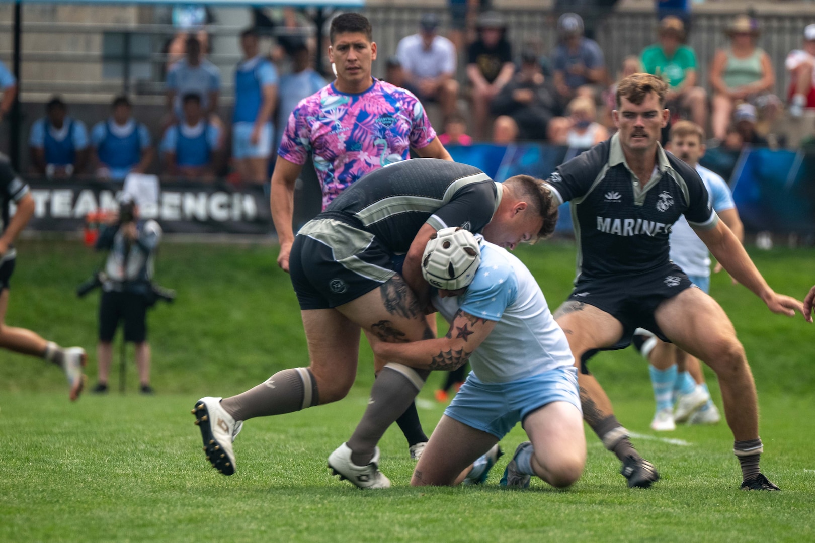 U.S. Marine Corps Lance Cpl. Luis Camacho, back for the U.S. Marine Corps Men’s 7s Rugby team, enters a tackle. Service members compete in a three-day tournament at Rugbytown USA during the 2025 Armed Forces Men’s 7s Championship at Infinity Park in Glendale, Co. Armed Forces Sports fosters goodwill by promoting physical fitness, providing competitive opportunities for military athletes at national and international levels, enhancing recruitment and retention through sports diplomacy, and building strategic partnerships with allied nations. (U.S. Department of Defense photo by Mass Communication Specialist 2nd Class Theodore C. Lee)