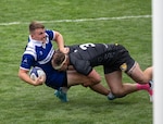Army's 1st lt. Matthew Meehan delivers a tackle on Air Force 1st lt. Jordan Savage during the 2025 Armed Forces Men’s Rugby Championships held in conjunction with Rugbytown 7’s Tournament in Glendale, Colo. from August 22-24. Service members from the Army, Marine Corps, Navy, Air Force (with Space Force players), and Coast Guard battle it out for gold.  (Photo by Senior Chief Bryce Bruns)