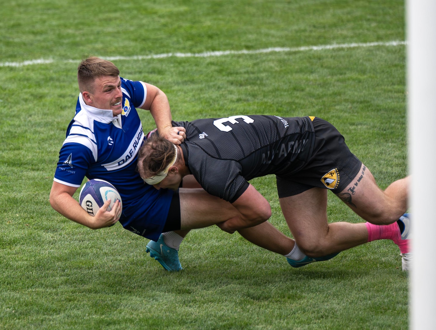 Army's 1st lt. Matthew Meehan delivers a tackle on Air Force 1st lt. Jordan Savage during the 2025 Armed Forces Men’s Rugby Championships held in conjunction with Rugbytown 7’s Tournament in Glendale, Colo. from August 22-24. Service members from the Army, Marine Corps, Navy, Air Force (with Space Force players), and Coast Guard battle it out for gold.  (Photo by Senior Chief Bryce Bruns)