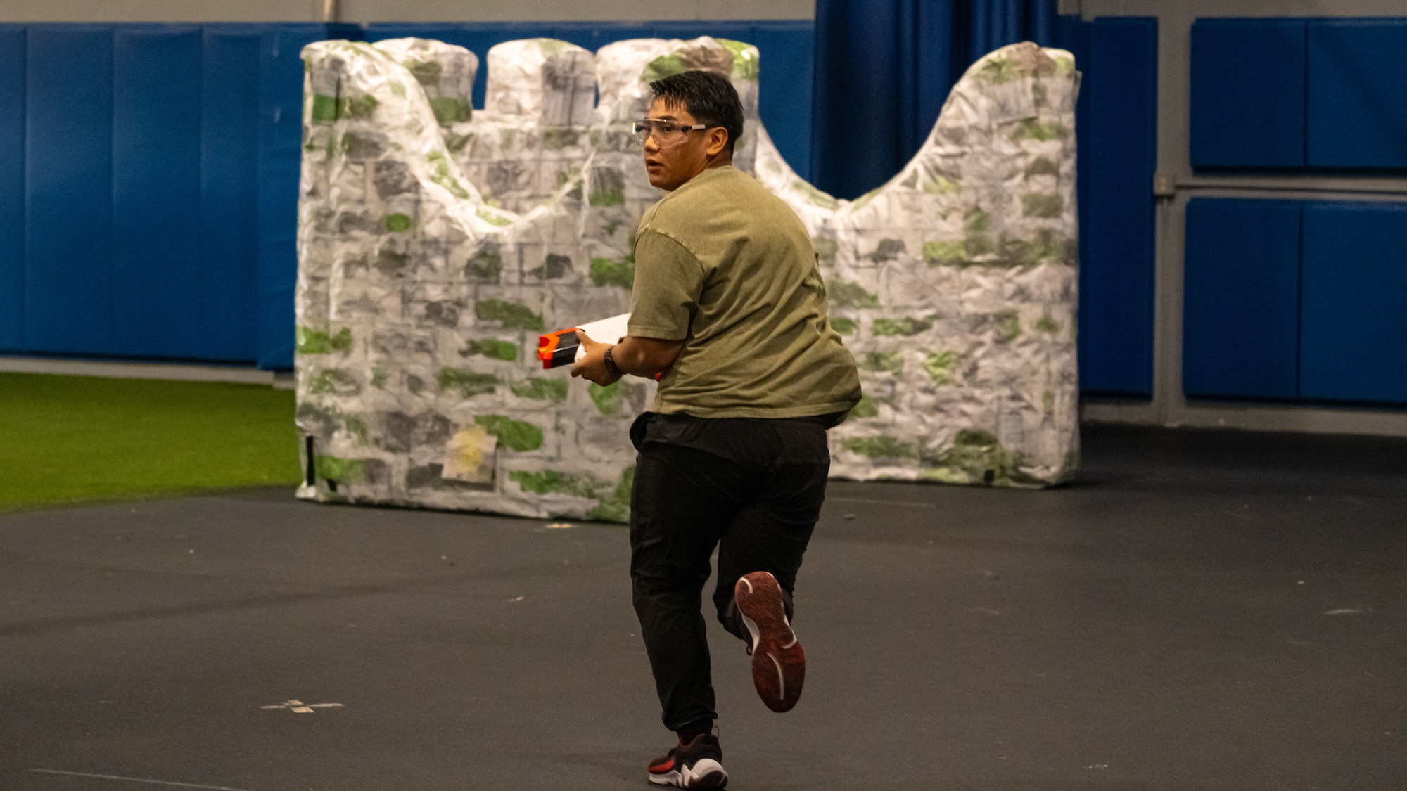 An Airman possessing a Nerf gun sprints during the Summer Games at Minot Air Force Base, North Dakota, Aug. 22, 2025. The Summer Games have been taking place since 2015, promoting physical health, camaraderie and competition.