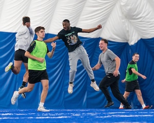 Airmen celebrate winning a soccer match during the Summer Games at Minot Air Force Base, Aug. 22, 2025. The Summer Games is an annual event at Minot AFB featuring a variety of sporting competitions designed to strengthen camaraderie and foster teamwork across Team Minot.