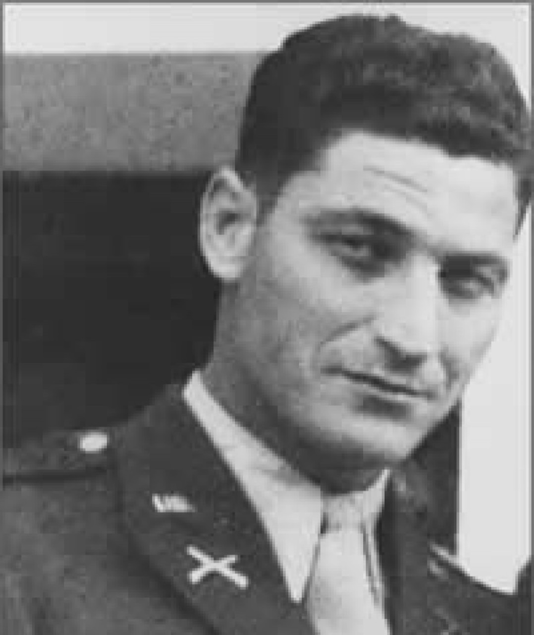 A man in a military dress uniform poses for a photo.