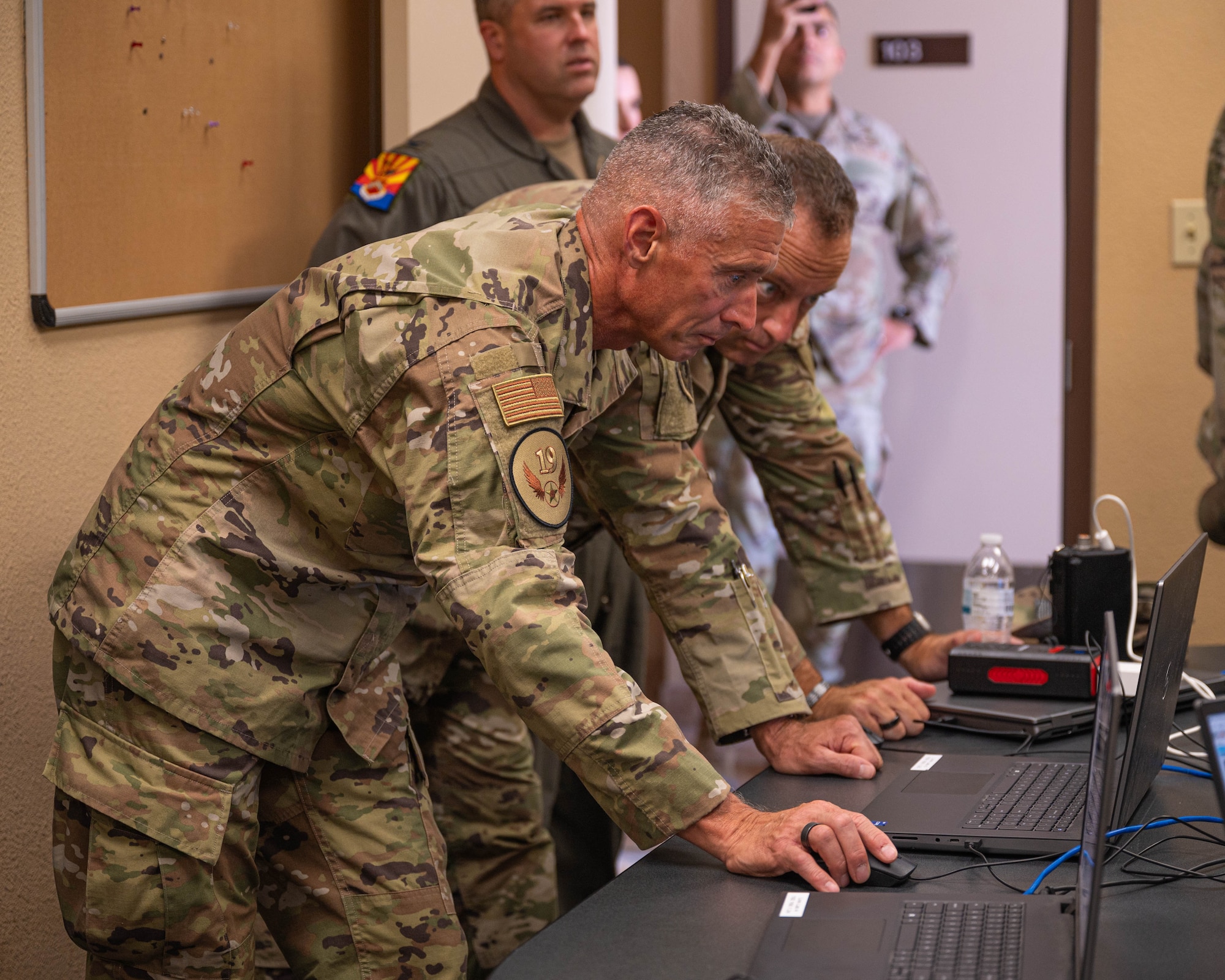U.S. Air Force Maj. Gen. Gregory Kreuder, 19th Air Force commander, and Chief Master Sgt. Keith Scott, 19th Air Force command chief, review operations at the 607th air control squadron