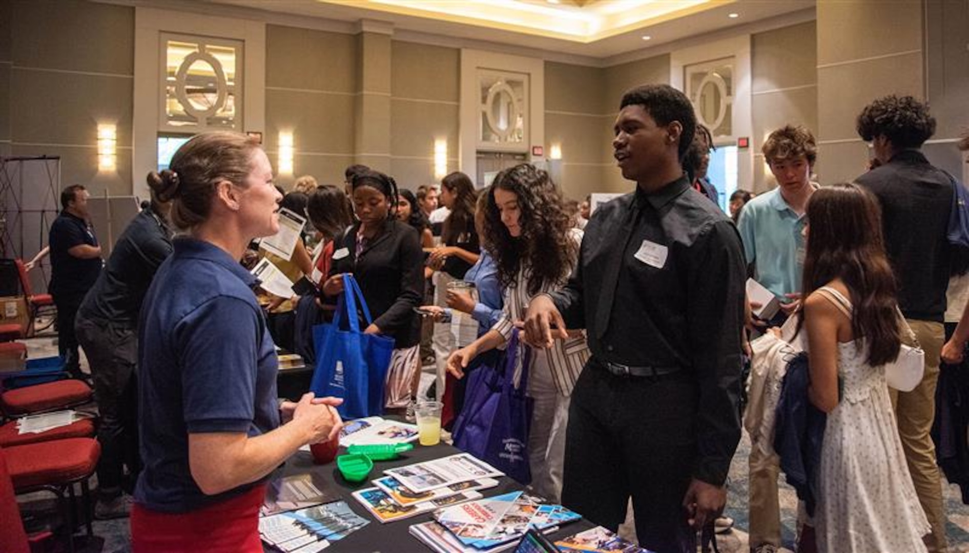 Lauren Hanyok, Capital Tech Bridge Director for Naval Surface Warfare Center, Carderock Division, discusses opportunities at NSWC Carderock with Montgomery County Public Schools’ Summer RISE (Reimagining an Innovative Student Experience) program interns at the program career fair session at the Bethesda North Marriott Hotel and Conference Center in Rockville, Md., July 25, 2024. The session gives students and companies who participated in the program the opportunity to network and learn about different future opportunities, like those offered at Naval Surface Warfare Center, Carderock Division. Carderock is one of the Navy’s pre-eminent research and development facilities that specializes in critical ship design components headquartered in West Bethesda, Maryland. The Carderock Division supports small-scale model testing and evaluation of next-generation surface ships and underwater vessels.