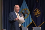 Matt Beebe speaking into microphone to provide opening remark.