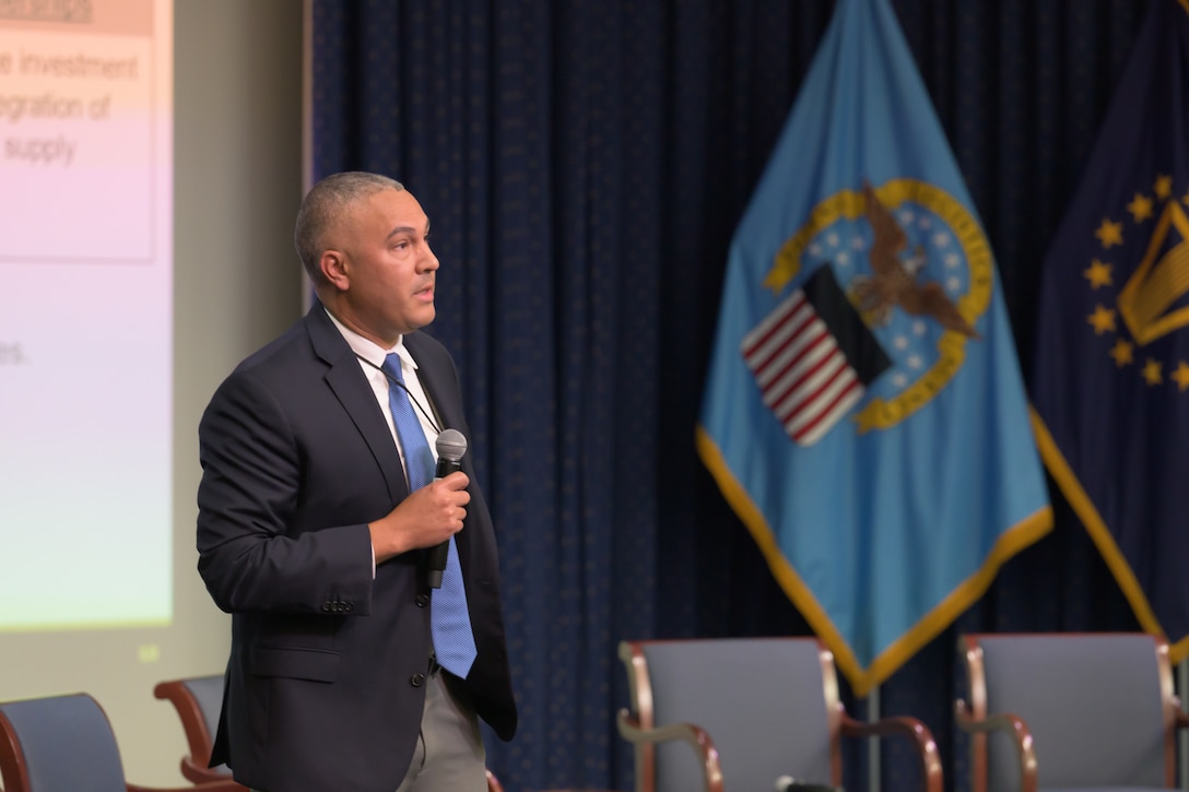 Eric Malta speaking into microphone.
