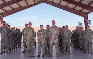 U.S. Air Force Maj. Gen. Gregory Kreuder, Nineteenth Air Force commander, Chief Master Sgt. Keith Scott, Nineteenth Air Force command chief, and Staff Sgt. Tawny Parnell, 56th Equipment Maintenance Squadron training supervisor, take a photo with the 56th EMS