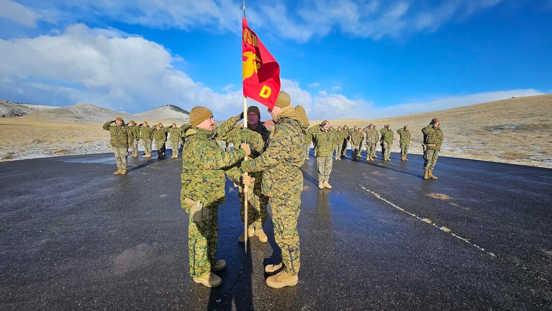 U.S. Marine Corps Capt. Garrett Gundy, incoming commanding officer, Detachment D, Force Headquarters Group, Marine Forces Reserve, shakes hands with Capt. Avery Moore, outgoing commanding officer, during a change of command ceremony at Ft. Harrison, Helena, Montana, March 20, 2025. The change of command ceremony represents the official passing of authority from the outgoing to incoming commander. (U.S. Marine Corps photo by courtesy of 4th Law Enforcement Battalion)
