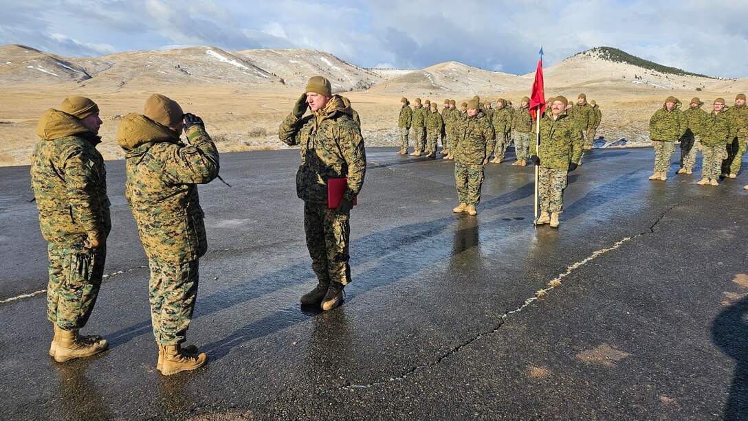 U.S. Marine Corps Capt. Avery Moore, outgoing commanding officer, Detachment D, 4th Law Enforcement Battalion, Force Headquarters Group, Marine Forces Reserve, holds a formation with Capt. Garrett Gundy, incoming commanding officer, during a change of command ceremony at Ft. Harrison, Helena, Montana, March 20, 2025. The change of command ceremony represents the official passing of authority from the outgoing commander to the incoming commander. (U.S. Marine Corps photo by courtesy of 4th Law Enforcement Battalion)