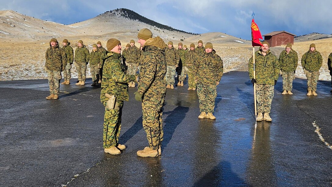 U.S. Marine Corps Capt. Garrett Gundy, incoming commanding officer, Detachment D, Force Headquarters Group, Marine Forces Reserve, shakes hands with Capt. Avery Moore, outgoing commanding officer, during a change of command ceremony at Ft. Harrison, Helena, Montana, March 20, 2025. The change of command ceremony represents the official passing of authority from the outgoing to incoming commander. (U.S. Marine Corps photo by courtesy of 4th Law Enforcement Battalion)