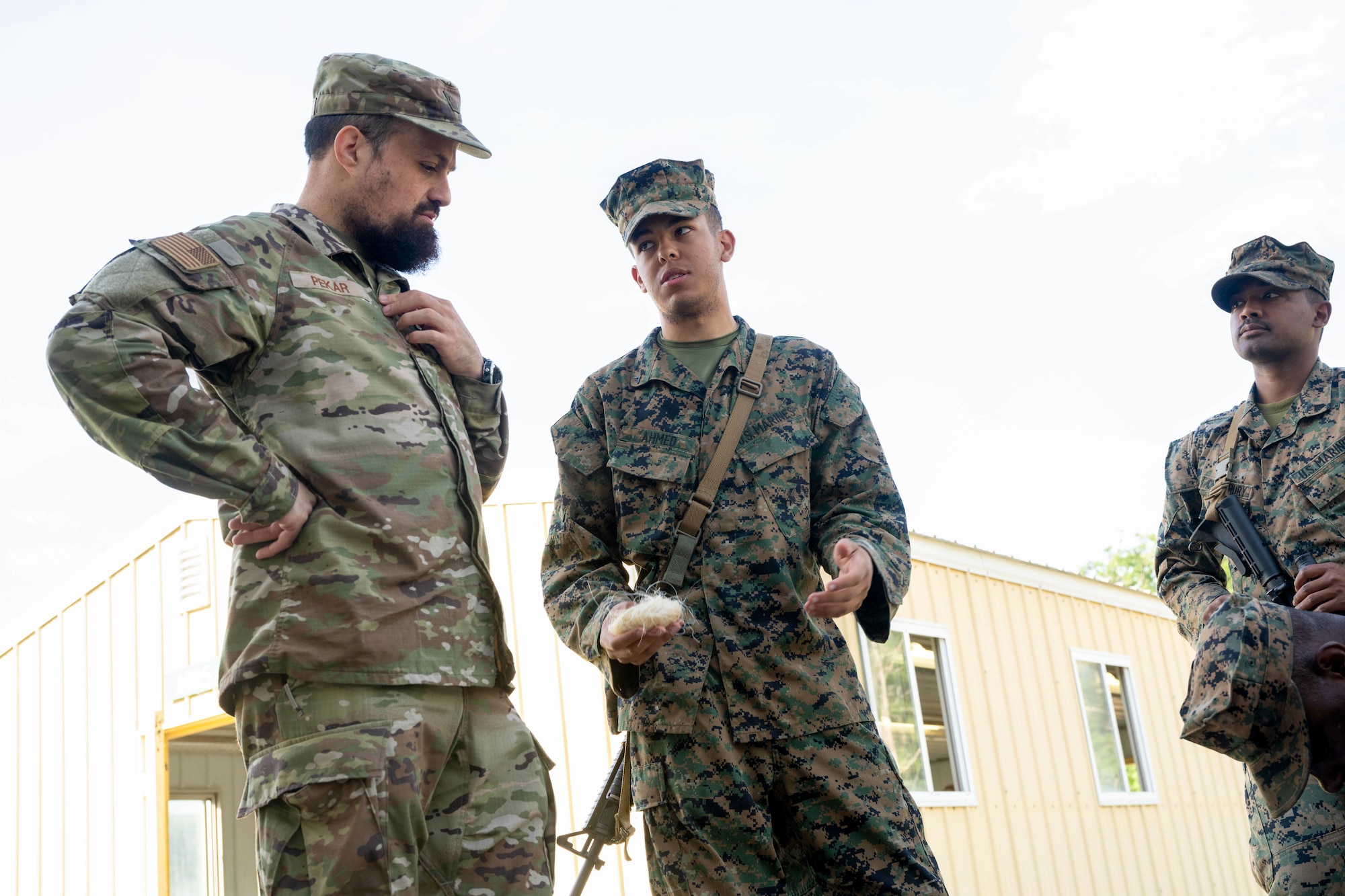 U.S. Air Force Ch, Capt. Levy Pekar, 86th Airlift Wing readiness and training chaplain, speaks to Personnel, Retrieval and Processing company Marines about Muslim burial rites during a capability display of the prototype for the "Care for the Dead and Dying kit" on Camp Grayling, Michigan, Aug. 10, 2025. Pekar participated in the exercise Northern Strike as a part of the religious affairs personnel team. (U.S. Air Force photo by Senior Airman Madeline Baisey)