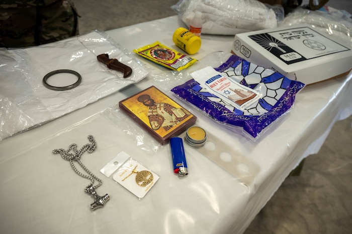 A prototype display of a "Death for the Care and Dying kit" lies on a table in the warehouse for the expeditionary mortuary at Grayling Army Airfield, Aug. 11, 2025. The kit contains religious burial items for faith groups that require care after death. (U.S. Air Force photo by Senior Airman Madeline Baisey)