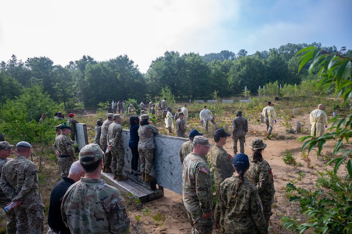 The Joint Fatality Management Working Group observes a vulture as a part of a walking tour of Camp Grayling's participation in the mortuary aspect of exercise Northern Strike 25-2 at Camp Grayling, Michigan, Aug. 13, 2025. The working group is a collaborative effort by multiple agencies to plan for and respond to a mass fatality incident. (U.S. Air Force photo by Senior Airman Madeline Baisey)