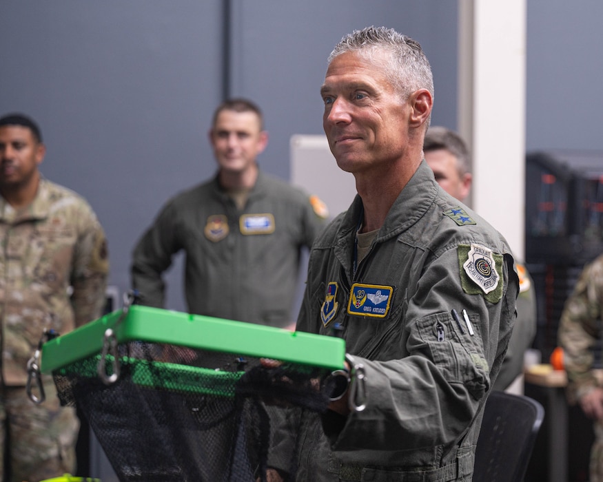 U.S. Air Force Maj. Gen. Gregory Kreuder, 19th Air Force commander, reviews a Fighter Country Innovation project