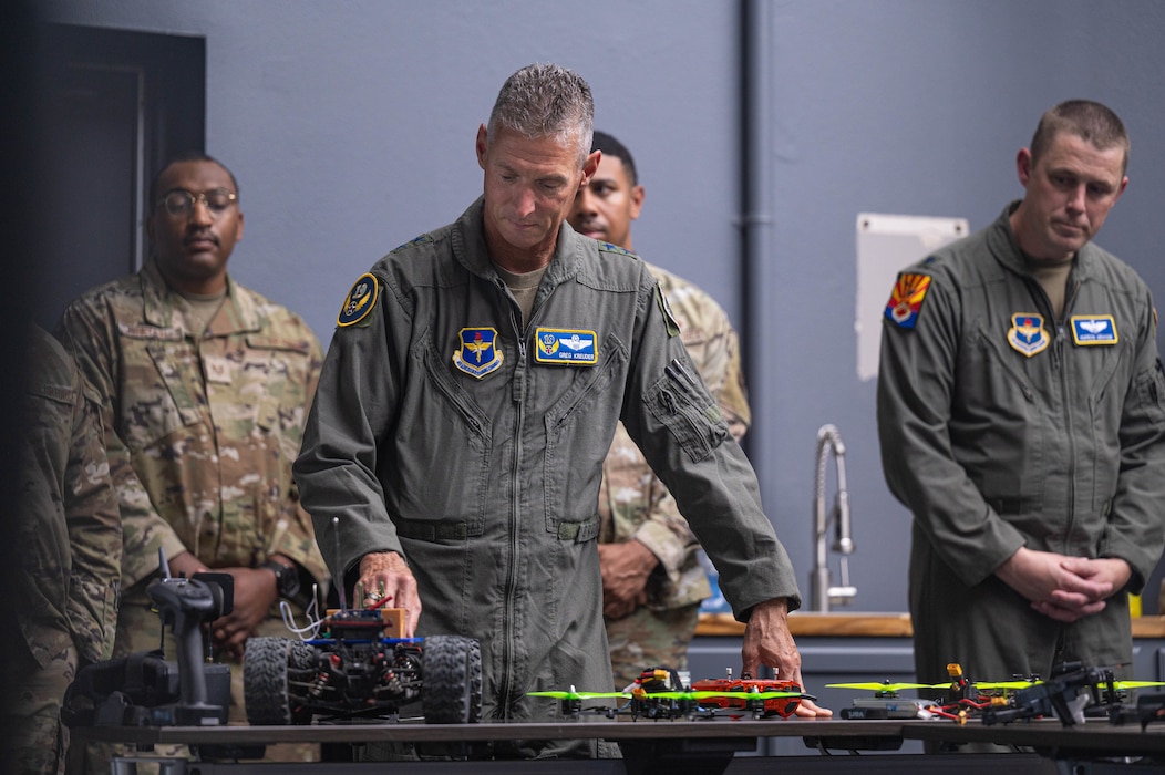 U.S. Air Force Maj. Gen. Gregory Kreuder, 19th Air Force commander, reviews a Fighter Country Innovation C-4 replica,