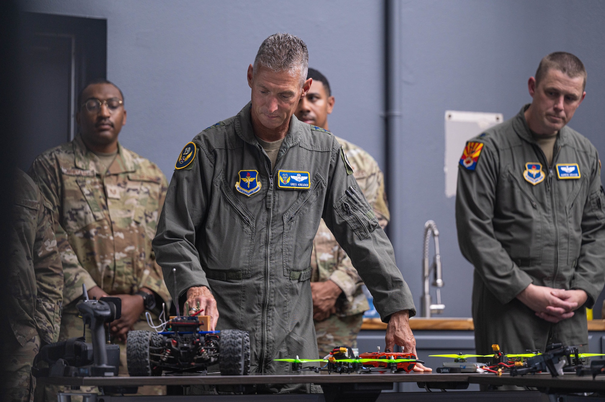 U.S. Air Force Maj. Gen. Gregory Kreuder, 19th Air Force commander, reviews a Fighter Country Innovation C-4 replica,