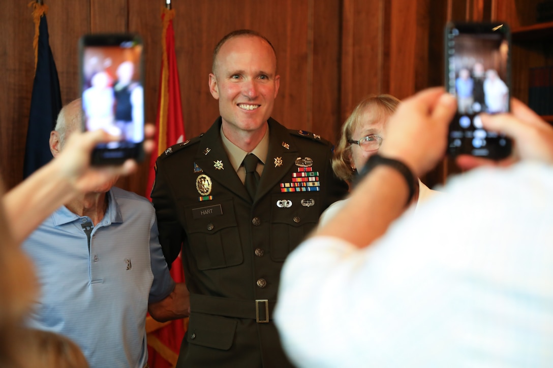 Newly promoted U.S. Army Col. Derek Hart poses for photos with his mom and dad after his promotion ceremony at the Louisville Country Club in Louisville, Kentucky, Aug. 20, 2025.