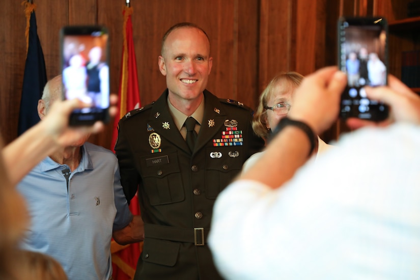 Newly promoted U.S. Army Col. Derek Hart poses for photos with his mom and dad after his promotion ceremony at the Louisville Country Club in Louisville, Kentucky, Aug. 20, 2025.