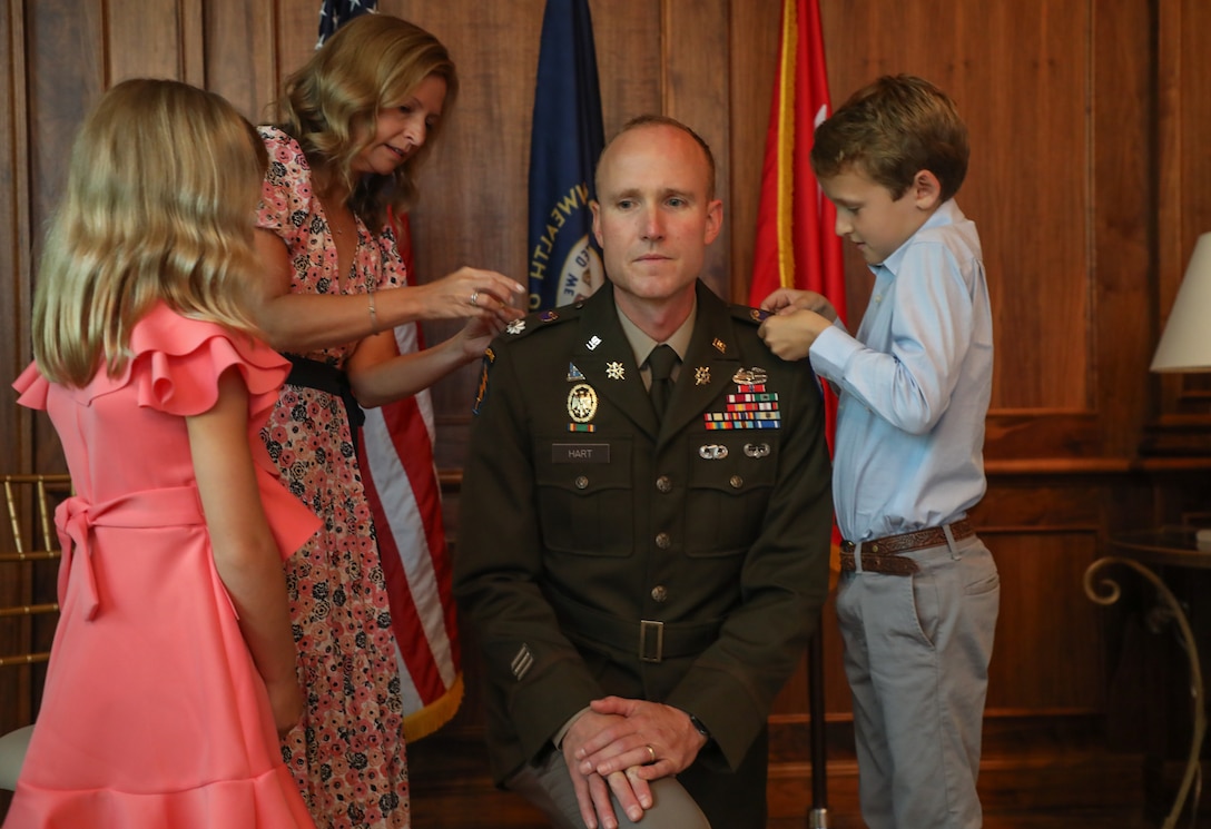U.S. Army Col. Derek Hart's family pins his new rank to his uniform during his promotion to ceremony at the Louisville Country Club in Louisville, Kentucky, Aug. 20, 2025.