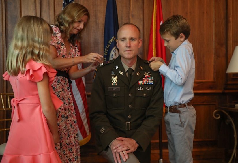 U.S. Army Col. Derek Hart's family pins his new rank to his uniform during his promotion to ceremony at the Louisville Country Club in Louisville, Kentucky, Aug. 20, 2025.