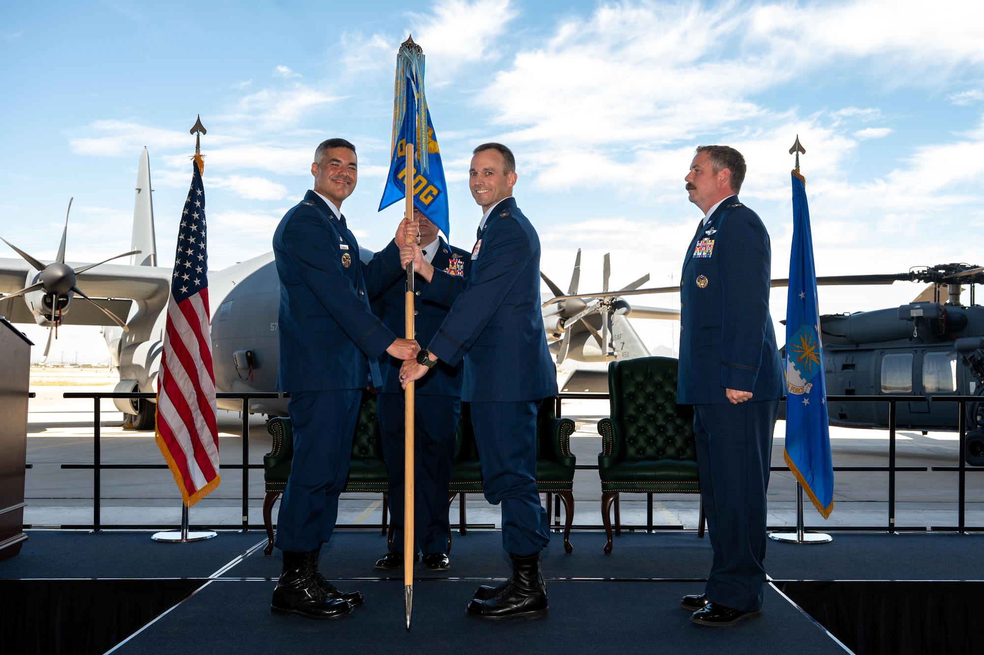 U.S. Air Force Col. Jose Cabrera, 355th Wing commander, presents the guidon to Col. Nicholas Morgans, 563rd Rescue Group incoming commander, during the 563rd RQG Change of Command at Davis-Monthan Air Force Base, Arizona, Aug. 28, 2025. Morgans took command after his previous assignment as director of operations at Second Air Force. (U.S. Air Force photo by Senior Airman Jasmyne Bridgers-Matos)