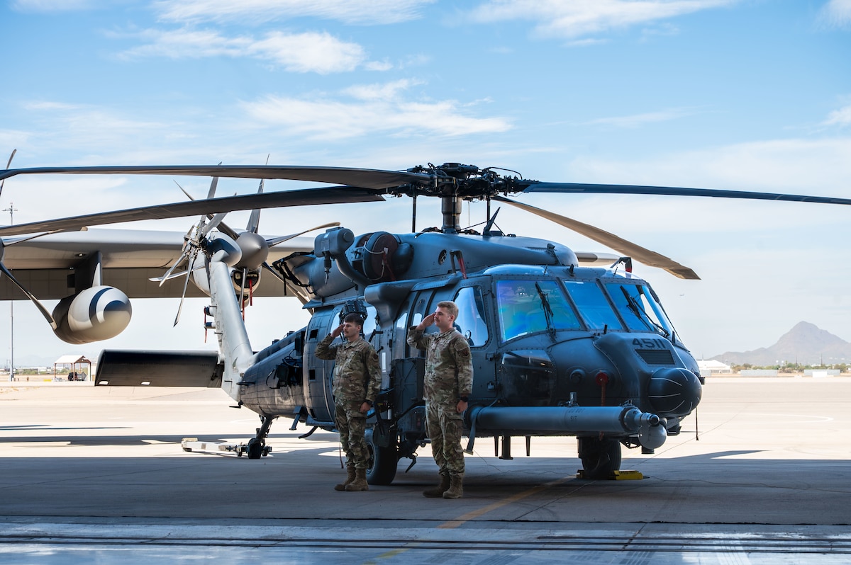U.S. Airmen assigned to the 55th Rescue Generation Squadron present the commander’s aircraft, an HH-60W Jolly Green II helicopter, to Col. Nicholas Morgans, 563rd Rescue Group incoming commander, during the 563rd RQG Change of Command ceremony at Davis-Monthan Air Force Base, Arizona, Aug. 28, 2025. The aircraft’s presentation symbolized the 563rd's combat search and rescue mission, heritage and capabilities. (U.S. Air Force photo by Senior Airman Jasmyne Bridgers-Matos)