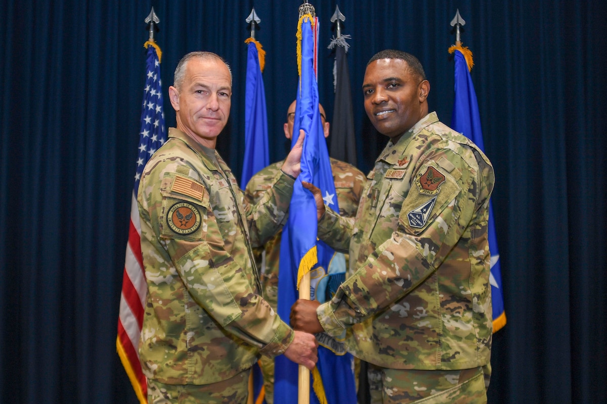 Acting Vice Chief of Staff of the Air Force Lt. Gen. Scott L. Pleus passes Brig. Gen. Otis C. Jones the Air Force Safety Center flag during an assumption of command ceremony at Kirtland Air Force Base, N.M., Aug. 28, 2025.