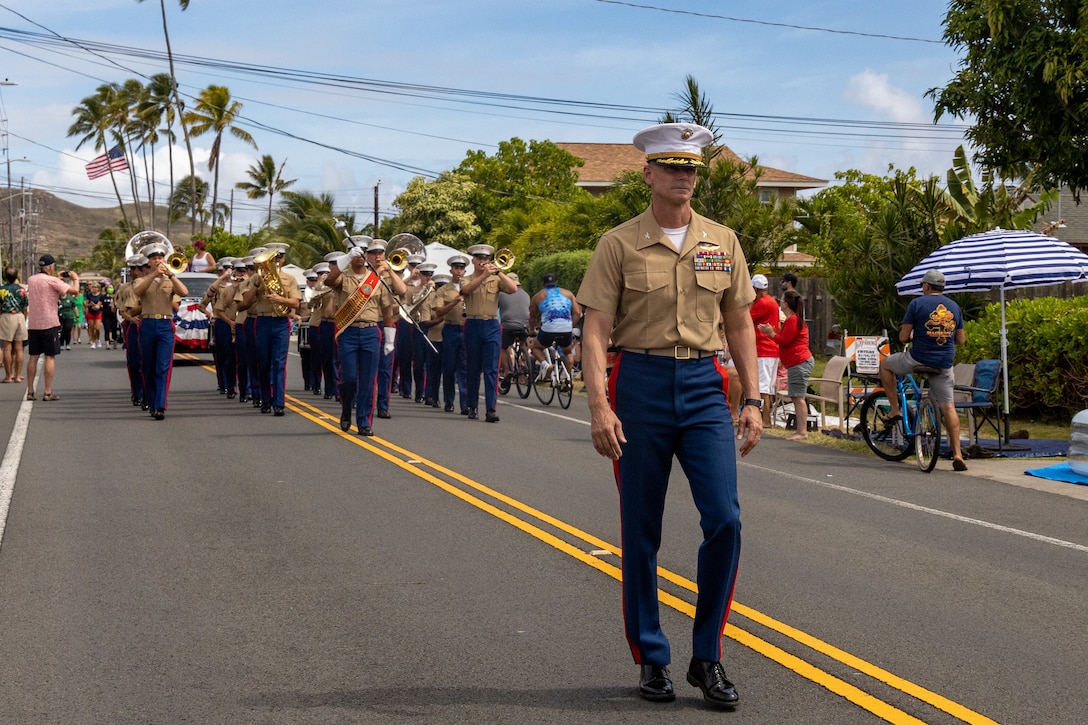 Col. Jeremy Beaven, commanding officer of Marine Corps Base Hawaii, and Marines with The Marine Corps Forces Pacific (MARFORPAC) Band march in formation during the Kailua Independence Day Parade in Kailua, Hawaii, July 4, 2025.