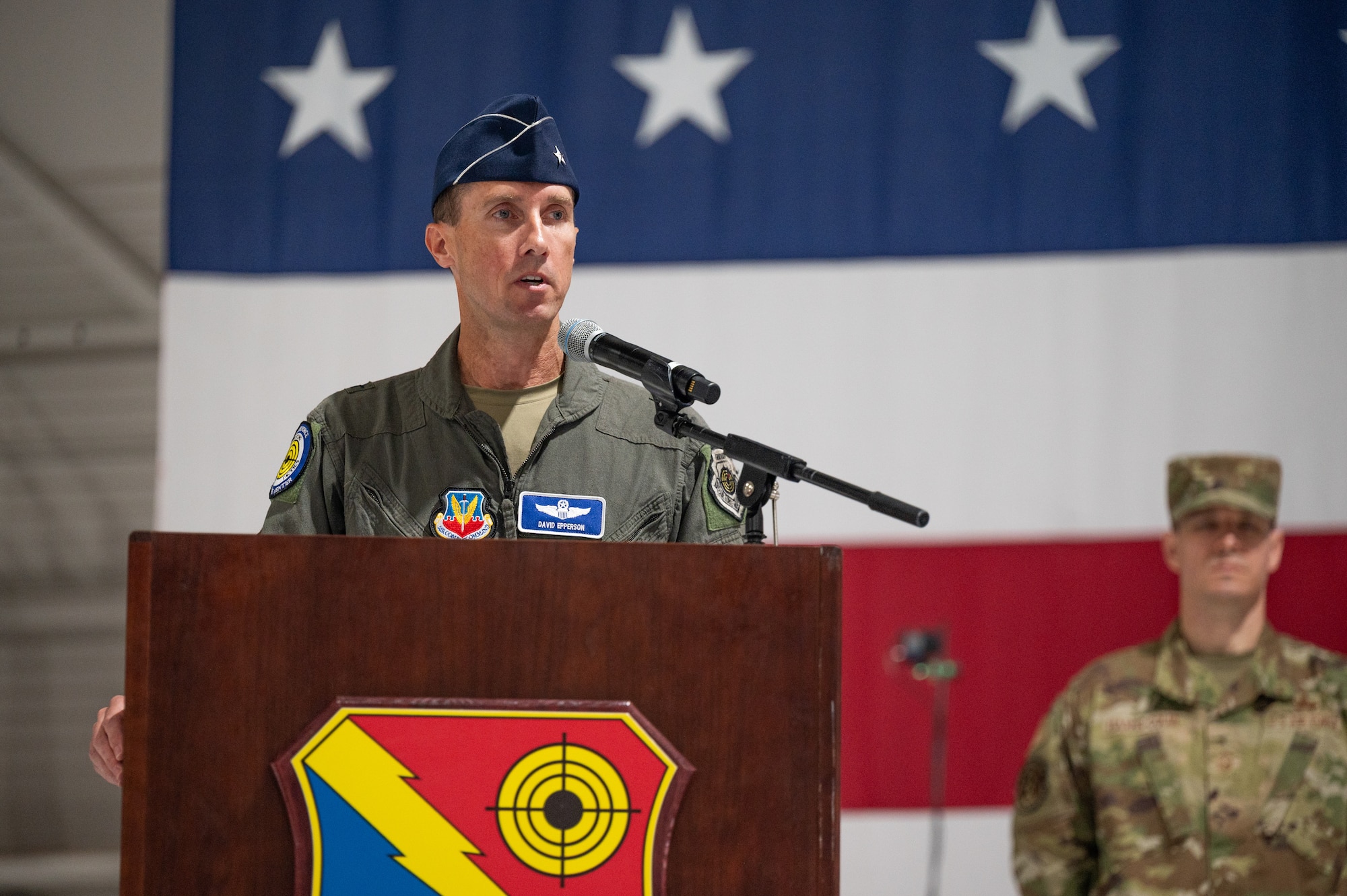 An Airman speaks at a podium.