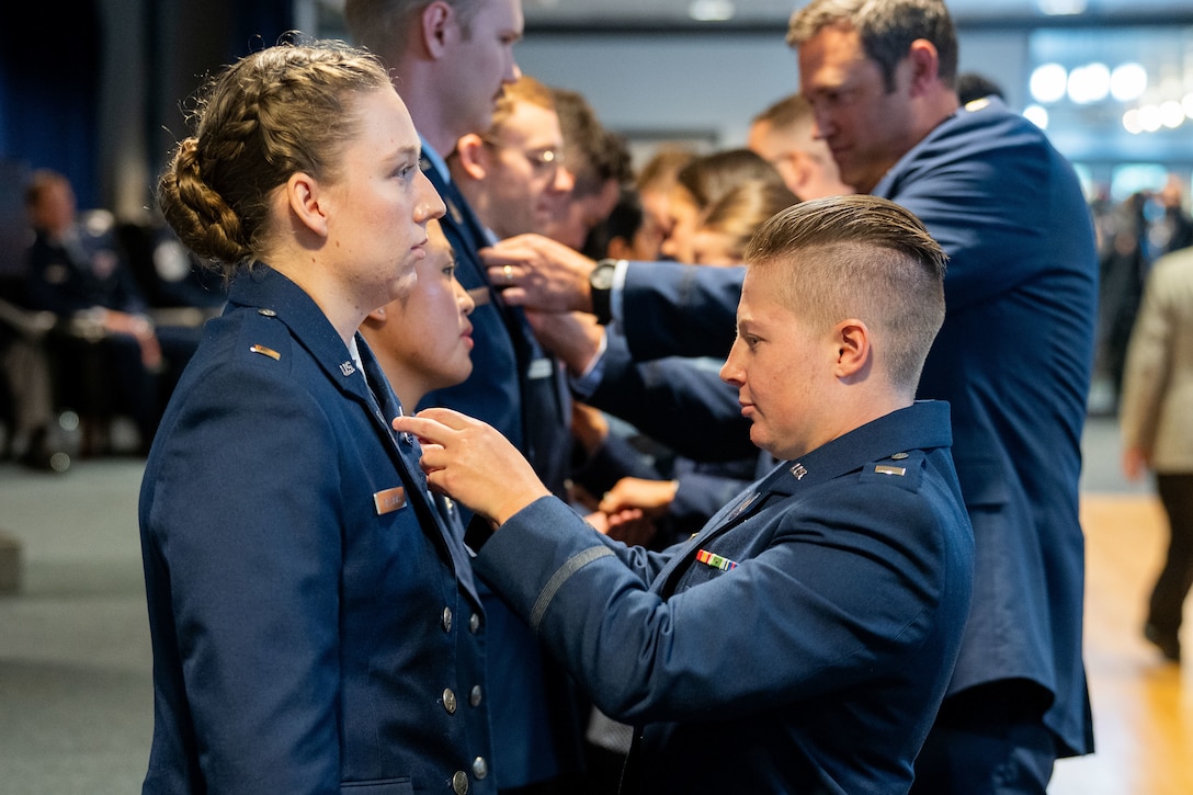 OTC graduation with Guardians in uniform. Photos feature pinning ceremony and officers in their formal blues.