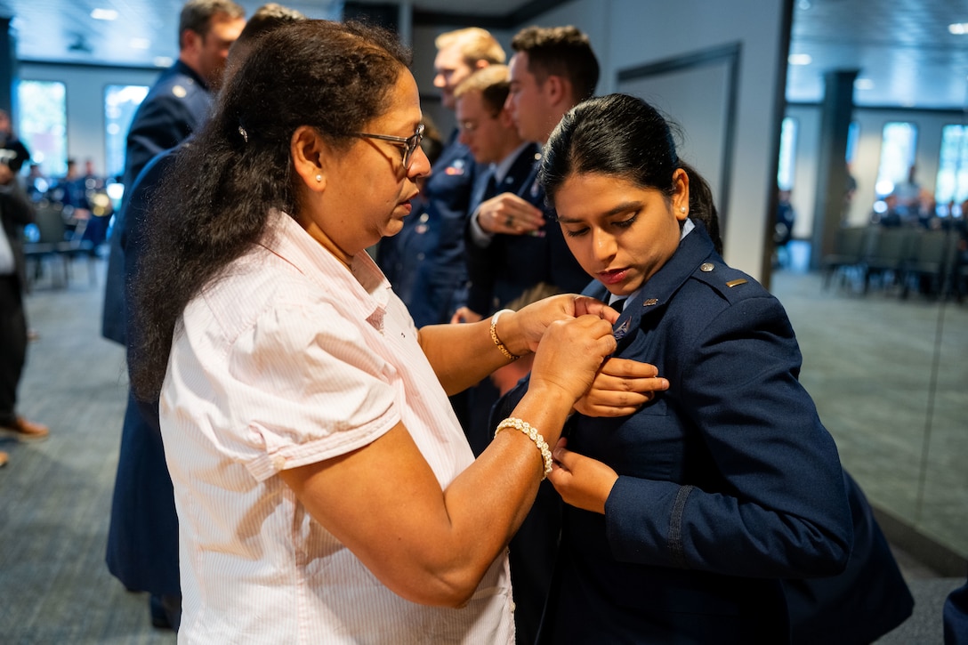 OTC graduation with Guardians in uniform. Photos feature pinning ceremony and officers in their formal blues.