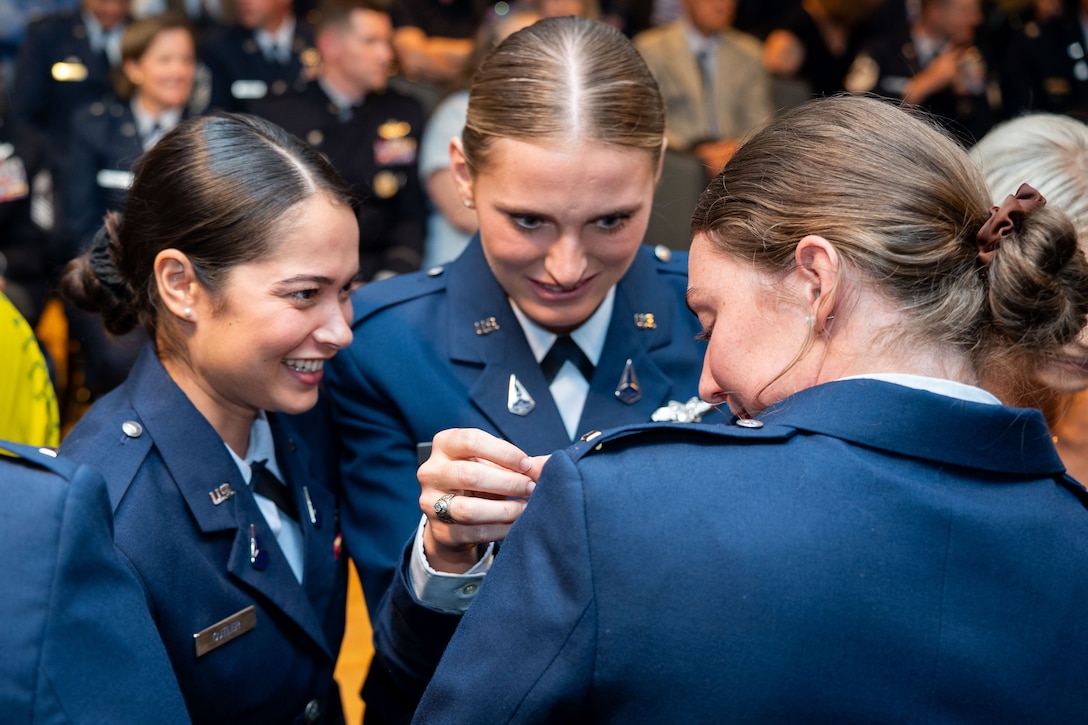 OTC graduation with Guardians in uniform. Photos feature pinning ceremony and officers in their formal blues.