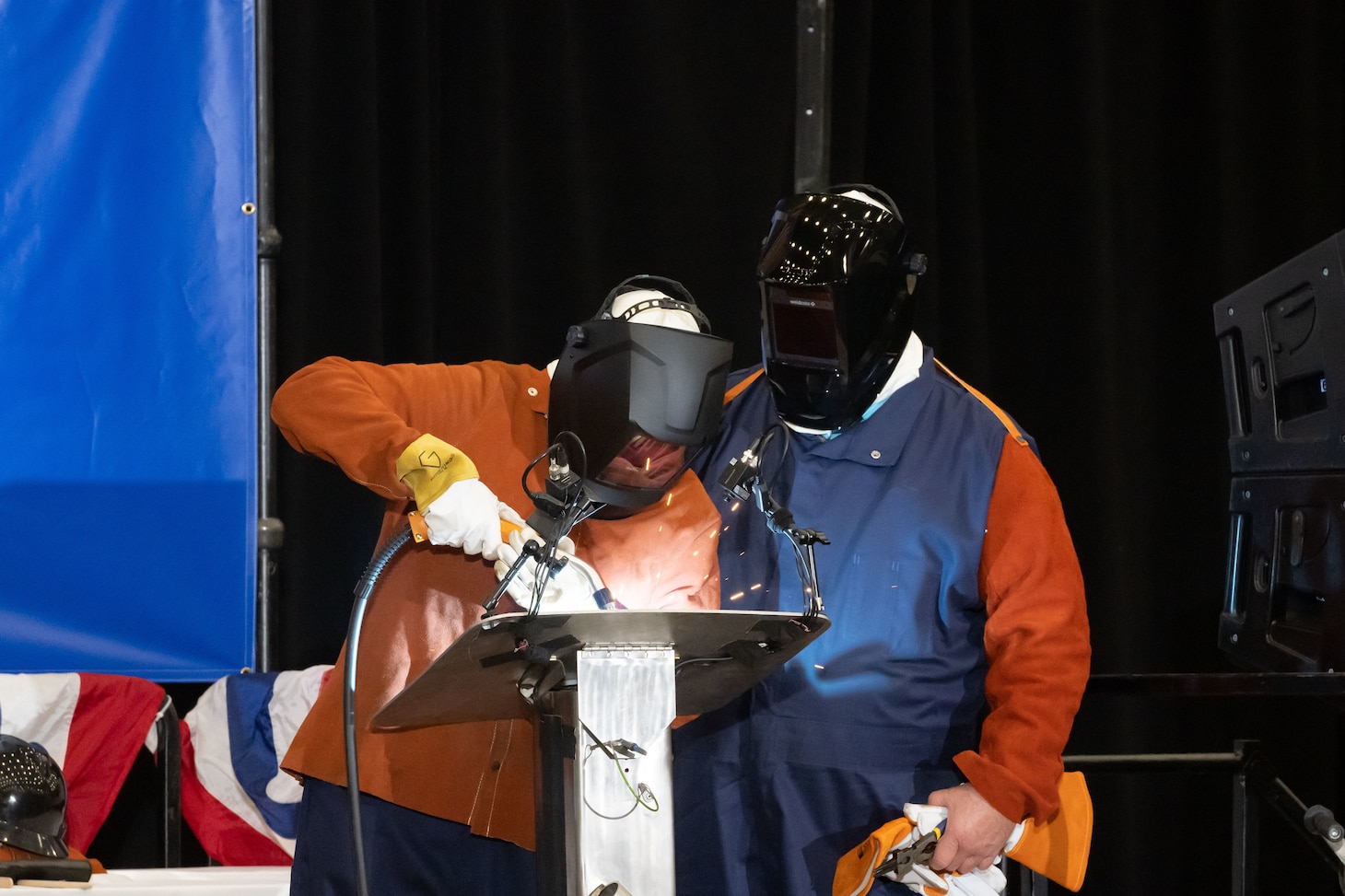 Dr. Kelly Geurts, ship sponsor of the future Columbia-class ballistic missile submarine USS Wisconsin (SSBN 827), welds her initials into the ship’s keel during its keel-laying ceremony under the supervision of General Dynamics Electric Boat welder Robert Ray Jr.