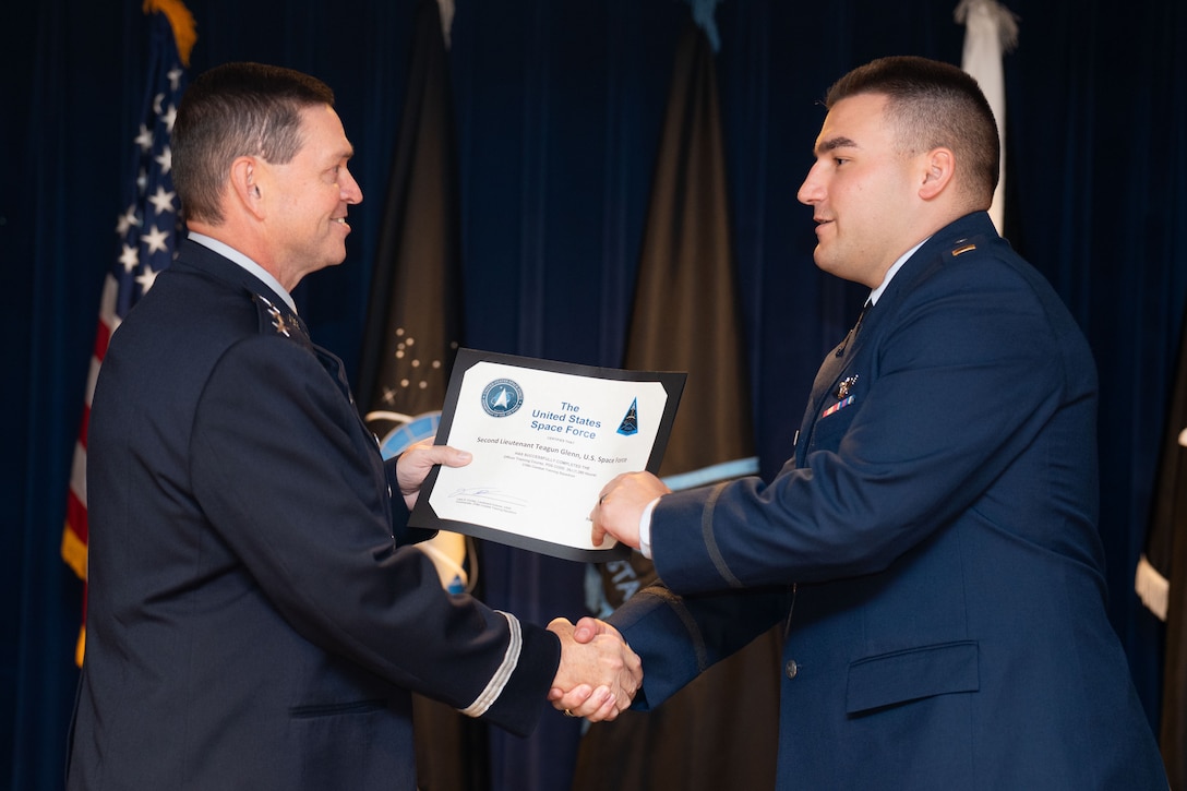 OTC graduation with Guardians in uniform. Photos feature pinning ceremony and officers in their formal blues.