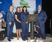 From the left, president of General Dynamics Electric Boat (GDEB) Mark Rayha, Wisconsin Matron of Honor Sarah Millar, future USS Wisconsin (SSBN 827) ship sponsor Dr. Kelly Geurts, and GDEB welder Robert Ray Jr. pose for a photo with a section of the ship’s keel featuring Dr. Geurts’ initials during the ship’s keel-laying ceremony.
