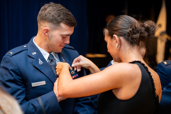 OTC graduation with Guardians in uniform. Photos feature pinning ceremony and officers in their formal blues.