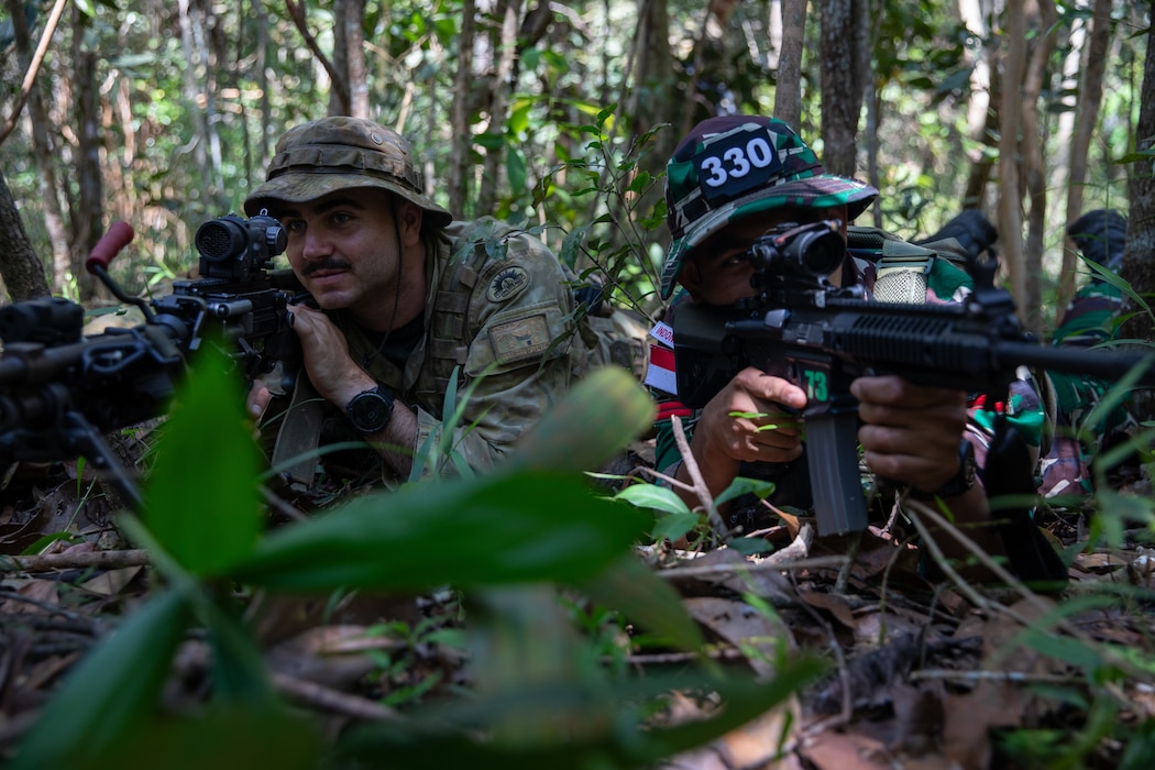 An Australian soldier assigned to the 1st Combat Engineer Regiment of the Australian Army and an Indonesian Army soldier assigned to the Indonesian Army Strategic Reserve Command hold security during a field training exercise during Super Garuda Shield 25 in Baturaja, Indonesia, Aug. 27, 2025.