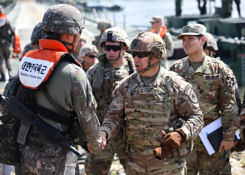 U.S. Army Maj. Gen. Charles Lombardo, commanding general of the 2d Infantry Division/ROK-U.S. Combined Division shakes hands with a Republic of Korea soldier assigned to the ROK 312th Wet Gap Battalion, ROK 7th Engineer Brigade, during combined wet gap crossing training as part of Ulchi Freedom Shield near Yeoju, South Korea, Aug 27, 2025.