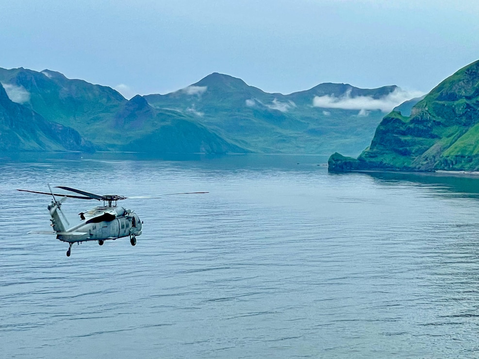 DUTCH HARBOR, Alaska (Aug. 21, 2025) An MH-60S Sea Hawk helicopter, attached to Helicopter Sea Combat Squadron (HSC) 14, flies over Dutch Harbor during exercise Northern Edge 2025 (NE25), Aug. 21. NE25 is an exercise led by U.S. Indo-Pacific Command that serves as a platform for joint, multi-domain operations to deliver high-end, realistic warfighter training, strengthen joint interoperability, and sharpen the air and sea-based combat readiness of U.S. and participating forces. (Courtesy photo)