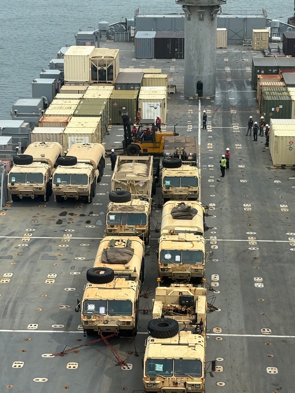 Military vehicles and equipment are prepared for an offload off Military Sealift Command chartered Motor Vessel Cape Hudson (T-AKR 5066) at the port of Bandar Lampung, Indonesia in support of exercise Super Garuda Shield 2025, Aug. 13.