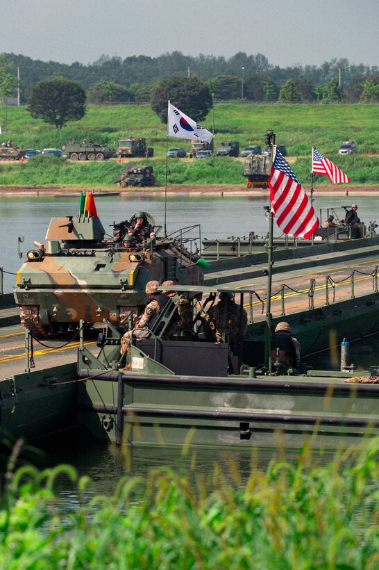 A Republic of Korea Army soldier assigned to the ROK 7th Engineer Brigade, drives over a completed bridge in a K200 armed vehicle during a combined wet-gap crossing training exercise as part of Ulchi Freedom Shield near Yeoju, South Korea, Aug. 27, 2025.