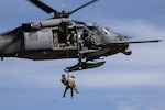 Alaska Air National Guard HH-60G Pave Hawk aviators and Guardian Angels, assigned to the 210th and 212th Rescue Squadrons, respectively, conduct a hoist rescue demonstration while participating in a multi-agency hoist symposium at Bryant Army Airfield on Joint Base Elmendorf-Richardson, Alaska, July 22, 2025. The symposium, hosted by Alaska Army National Guard aviators assigned to Golf Company, 2-211th General Support Aviation Battalion, included U.S. Coast Guard crews assigned to Sector Western Alaska and U.S. Arctic out of Air Stations Kodiak and Sitka, Alaska Air National Guardsmen with the 176th Wing rescue squadrons, U.S. Army aviators from Fort Wainwright’s 1-52nd General Support Aviation Battalion, Alaska State Troopers, and civilian search and rescue professional volunteers from the Alaska Mountain Rescue Group. The collaborative training drew on the participants’ varied backgrounds, experiences, and practices, to enhance hoist proficiency and collective readiness when conducting life-saving search and rescue missions in Alaska’s vast and austere terrain. (Alaska Army National Guard photo by Alejandro Peña)