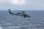 250822-N-UP681-1135 NORTH PACIFIC OCEAN (Aug. 22, 2025) An MH-60S Sea Hawk helicopter, attached to Helicopter Sea Combat Squadron (HSC) 14, takes off from the flight deck of the Nimitz-class aircraft carrier USS Abraham Lincoln (CVN 72) during exercise Northern Edge 2025 (NE25). NE25 is an exercise led by U.S. Indo-Pacific Command that serves as a platform for joint, multi-domain operations to deliver high-end, realistic warfighter training, strengthen joint interoperability, and sharpen the air and sea-based combat readiness of U.S. and participating forces. (U.S. Navy photo by Mass Communication Specialist Seaman Apprentice Gage Thomas)