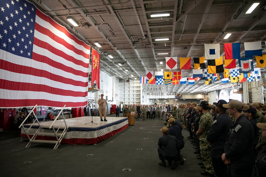 Chief of Naval Operations (CNO) Adm. Daryl Caudle addresses Sailors during an all-hands call in the hangar bay aboard the Nimitz-class aircraft carrier USS Harry S. Truman (CVN75) in Norfolk, Va., Aug. 28.